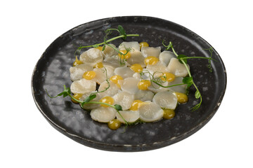 scallops sliced with sauce on a plate, carved out