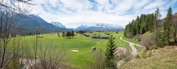 Fototapeta na wymiar view over Golf range Wallgau into the valley, upper bavaria in springtime