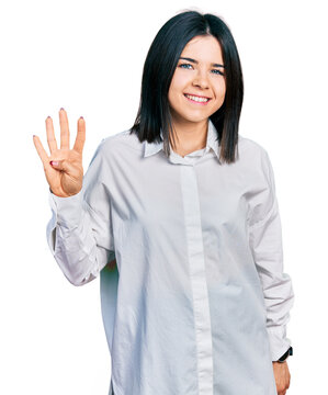 Young brunette woman with blue eyes wearing oversize white shirt showing and pointing up with fingers number four while smiling confident and happy.