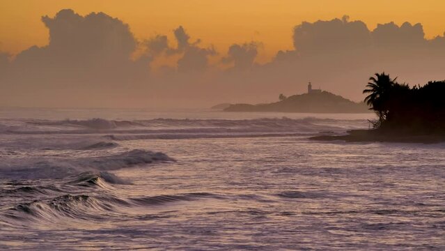 Dramatic lighthouse sunrise at Atlantic coast of Arecibo, Puerto Rico.