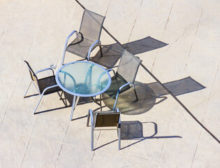 Shadow on the floor from a glass table with chairs - 768123131