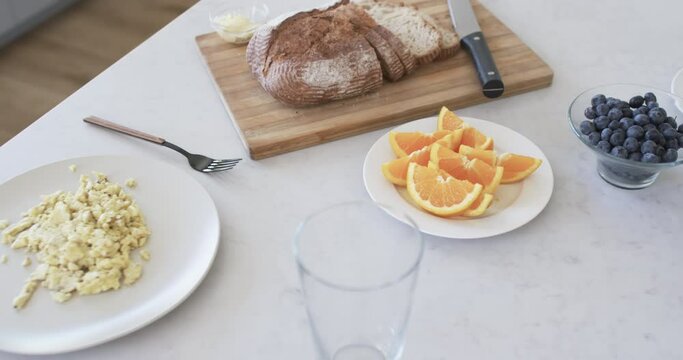 A breakfast spread is laid out on a marble countertop