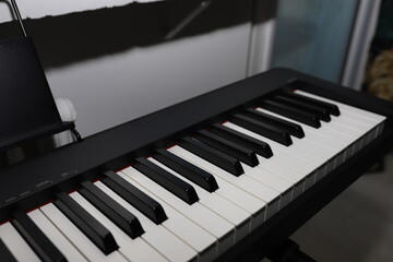 Portable digital piano in black. Digital piano in a black matte case.