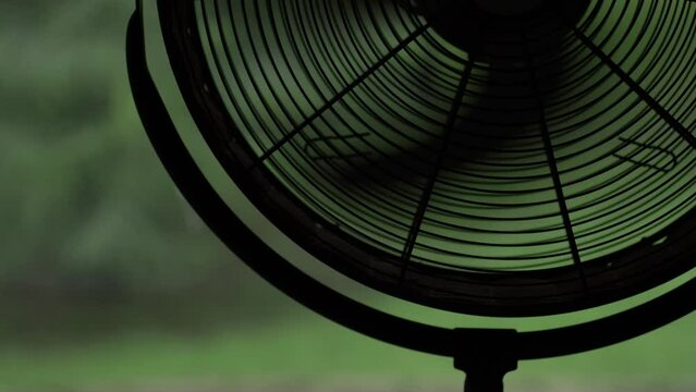 The electric domestic spinning fan in room. Close up, cinematic