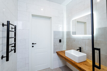 Fototapeta na wymiar Bathroom with sink, mirror, and towel rack Interior design fixtures