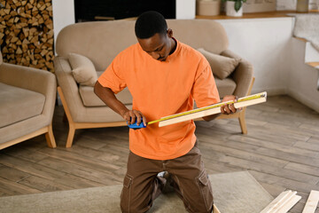 A young handsome black guy assembles a rack according to the instructions, but something doesn t...