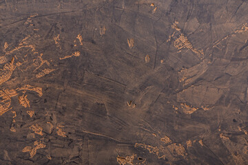 Abstract Composition, Dark Stone Surface with Traces of Cocoa Powder.