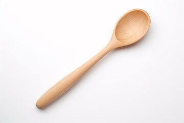 a wooden spoon on a white surface