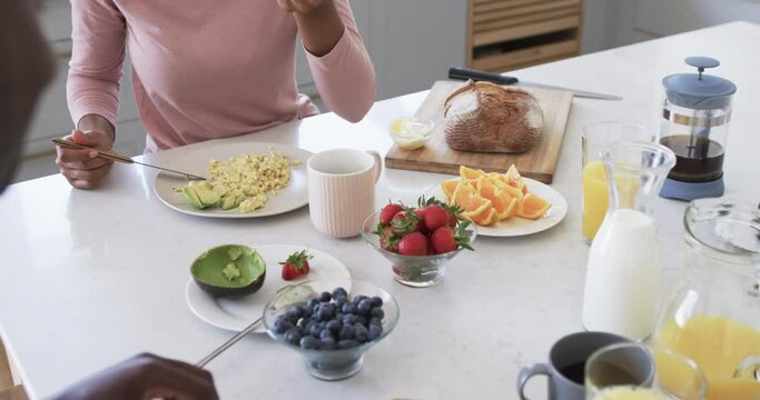 African American couple enjoys a healthy breakfast at home in the kitchen