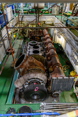 Main engine repairing. Inside engine room on big ship. Marine engine on vessel.