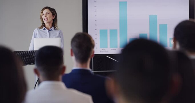 Presentation, meeting and woman with audience for business seminar, conference and discussion. Convention, corporate leader and speaker with chart for finance review, report and feedback in office