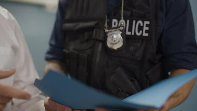 Police team reading case files at the station