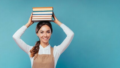 Happy young woman with stacked books on her head, isolated on blue background, with copy space 11.jpg, Happy young woman with stacked books on her head, isolated on blue background, with copy space