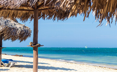 Close up shot of beach umbrellas made of palm trees. Holiday