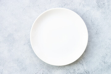 White plate and napkin at stone table. Table setting, Flat lay image.
