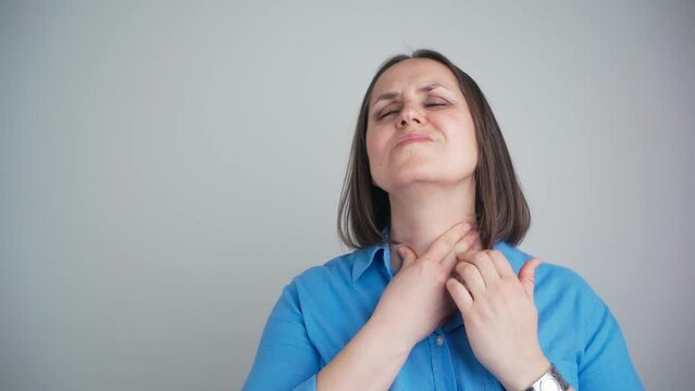 Woman thyroid gland control. Middle aged lady sweeping the laryngeal, laryngitis, goiter or Hypothyroidism. Disorder of the endocrine system. Hashimoto&rsquo;s Thyroiditis, Lymphocytic Thyroiditis.