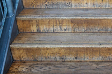 Wooden brown steps cross section with blue grey painted bannister 