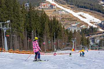 ski slope at a ski resort in spring. family holiday . school break
