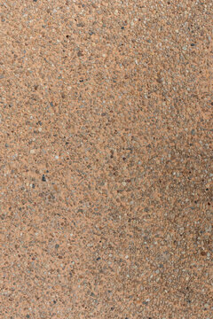 Vertical blank concrete brown rough wall for background. Beautiful brown exposed aggregate wall plastered surface background pattern.
