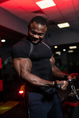Fototapeta na wymiar Strong bodybuilder working out with biceps muscles. Brutal heavy training man.