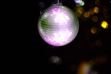Bright shiny disco ball light on dark background