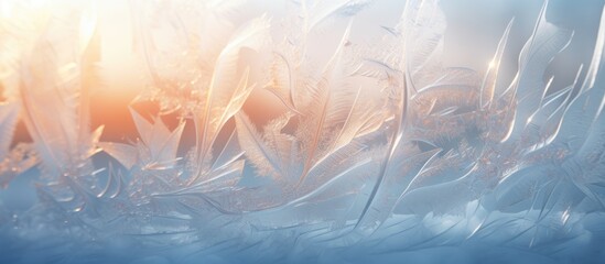 The image shows a close up of a window with intricate frost patterns forming on the glass. The sunlight hits the frost, creating a beautiful display against the winter background.
