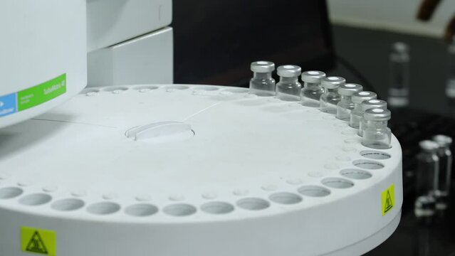 hplc vials in a science experiment Vials filling inside an autosampler of an HPLC machine inside view in a Scientific experimental laboratory for research development analysis and ipqa test study	