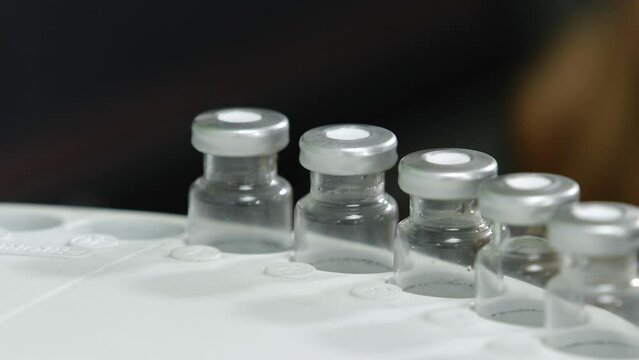 hplc vials in a science experiment Vials filling inside an autosampler of an HPLC machine inside view in a Scientific experimental laboratory for research development analysis and ipqa test study