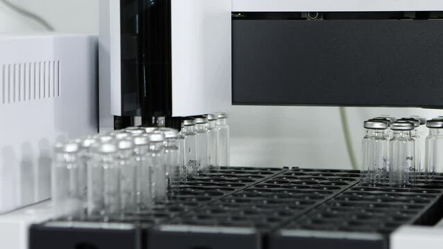 hplc vials in a science experiment Vials filling inside an autosampler of an HPLC machine inside view in a Scientific experimental laboratory for research development analysis and ipqa test study	
