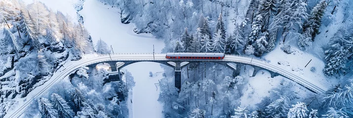 Fotobehang Landwasserviaduct Majestic Journey Through the Swiss Alps  Aerial View of a Train Traversing the Landwasser Viaduct in Winter