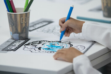 Close up of kid drawing at class room play time. The kid is wearing a scientific gown while painting a colorful artistic piece - Powered by Adobe