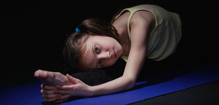 Portrait of young yogi girl practicing yoga lesson. Health, gymnastics, breathing, meditation, religion concept. Horizontal image.