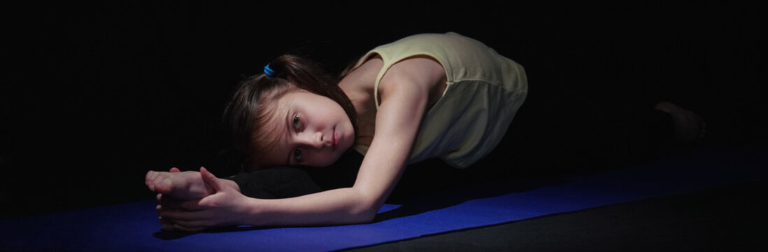 Close up portrait of young yogi girl practicing yoga lesson. Health, gymnastics, breathing, meditation, religion concept. Horizontal image.
