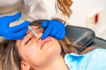 Adult woman getting a Botox injection in the lips