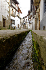Water flows through the streets of Candelario, Salamanca, Spain.