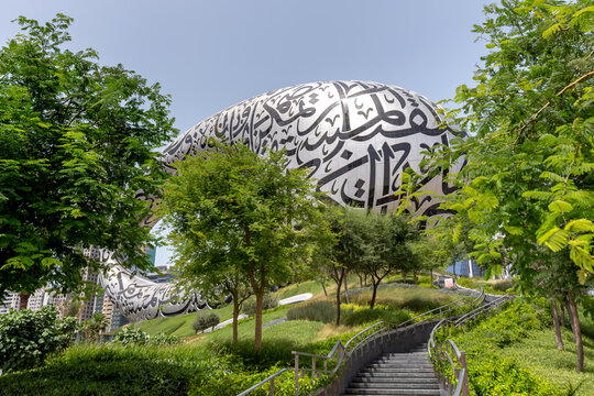 Exterior of the famous Museum of The Future in Dubai with green foliage of trees around it