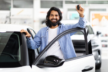Happy indian man showing new car keys