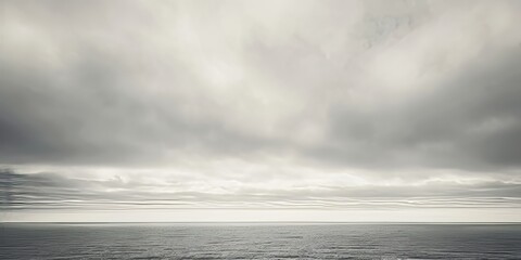 Black and white ocean with dramatic grey clouds above