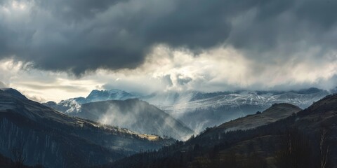 A stunning view of a mountain range against a dramatic grey sky filled with billowing clouds - Powered by Adobe