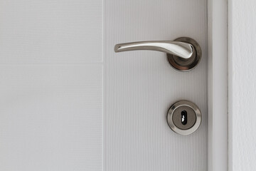 Silver Door Handle on an Opened White Door