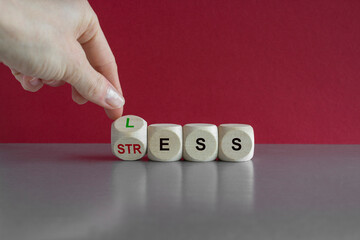 Symbol for less stress. Hand turns a dice and changes the word Stress to Less. Beautiful red...