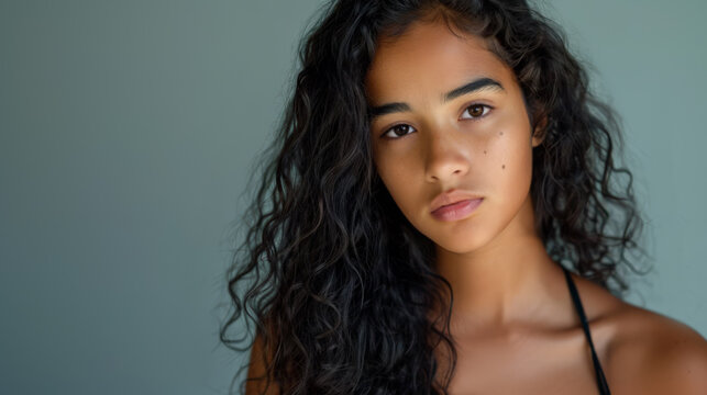Head and shoulders studio portrait of a beautiful Brazillian teenager.