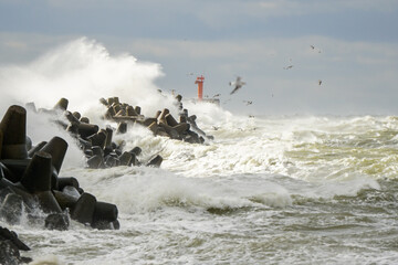 Big wave breaking on breakwater, stormy sea, crashing waves, wave splashing, hurricane season