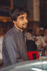 Portrait of a poor Middle aged Pakistani man, working in his shop