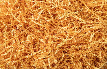 Yellow color shredded paper - gift box filler background. Flat lay view, studio shot.
