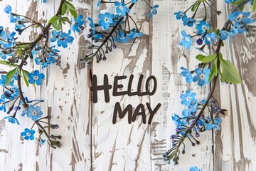"HELLO MAY", written in black text, on white wooden background with blue flowers Generative AI