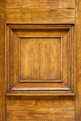 Detail of an ancient wooden door coated with varnish