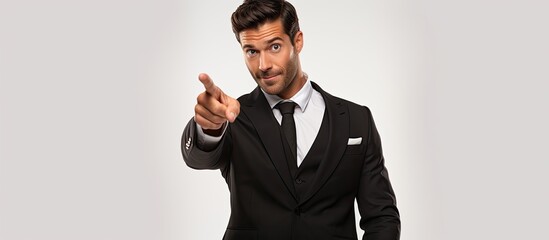 A professional man in a suit and tie is gesturing towards the camera in a confident manner