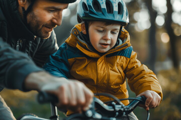 Obraz premium A man is helping a young boy on a bike