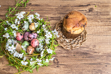 Colorful Quail Easter Eggs in nest and Easter bread  